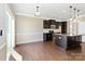 Modern kitchen features dark cabinetry, granite countertops, stainless steel appliances, and a large island at 217 Hydrangea Dr, Clover, SC 29710