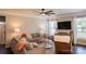 Inviting living room with large windows, comfortable seating, a ceiling fan, and stylish decor at 217 Hydrangea Dr, Clover, SC 29710