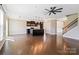 Open-concept living area with hardwood floors, ceiling fan, and open to the modern kitchen at 217 Hydrangea Dr, Clover, SC 29710