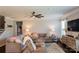 Cozy living room with neutral tones, ample seating, ceiling fan and a large entertainment center at 217 Hydrangea Dr, Clover, SC 29710