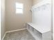 Mudroom with herringbone tile flooring, bench, and storage hooks at 217 Hydrangea Dr, Clover, SC 29710