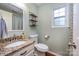 Charming bathroom with a granite countertop vanity, toilet, and wooden shelving at 2342 Castlecomer Dr, Charlotte, NC 28262