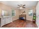 Comfortable bedroom with hardwood floors, ceiling fan, dresser, and a crib, ideal for a room at 2342 Castlecomer Dr, Charlotte, NC 28262