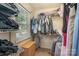 Well-organized walk-in closet with shelving, hanging rods, and a window for natural light at 2342 Castlecomer Dr, Charlotte, NC 28262
