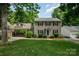 Charming two-story home with neutral siding, black shutters, and a well-manicured lawn, creating curb appeal at 2342 Castlecomer Dr, Charlotte, NC 28262