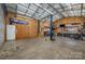 Interior of a large garage featuring two car lifts, workbenches, and ample storage space at 2342 Castlecomer Dr, Charlotte, NC 28262