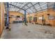 Spacious garage interior equipped with a car lift, work benches, and ample storage at 2342 Castlecomer Dr, Charlotte, NC 28262
