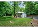 Exterior view of a detached metal garage with a well-maintained lawn at 2342 Castlecomer Dr, Charlotte, NC 28262
