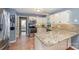 Bright kitchen featuring white cabinets, granite countertops, stainless steel appliances, and stylish backsplash at 2342 Castlecomer Dr, Charlotte, NC 28262