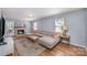 Cozy living room with fireplace, large sectional sofa, hardwood floors, and ample natural light at 2342 Castlecomer Dr, Charlotte, NC 28262