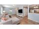 Open-concept living room with hardwood floors, a large sectional sofa, and an open kitchen view at 2342 Castlecomer Dr, Charlotte, NC 28262