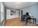 Well-lit office space with hardwood floors, custom shelving, and ample storage, ideal for work or hobbies at 2342 Castlecomer Dr, Charlotte, NC 28262