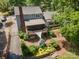 An aerial view of a home with a brick chimney, screened in porch, open deck, and landscaped backyard at 2342 Castlecomer Dr, Charlotte, NC 28262