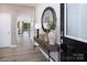 Inviting entryway featuring wood-look flooring, console table, and decorative mirror at 2635 Tillman St, Monroe, NC 28112