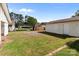 Spacious backyard featuring a detached garage, carport, and storage shed under a blue sky at 2729 S Ridge Ave, Concord, NC 28025