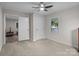 Cozy bedroom with plush carpeting, modern ceiling fan, and ample natural light from the window at 2729 S Ridge Ave, Concord, NC 28025