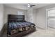 Bedroom boasts stylish wood-finished bed frame with mounted bedside lamps and ceiling fan at 2729 S Ridge Ave, Concord, NC 28025