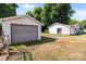 View of the detached garage and outbuilding with gravel driveway and mature trees at 2729 S Ridge Ave, Concord, NC 28025