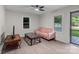 Bright living room featuring wood-look floors, a modern ceiling fan, and a comfortable pink sofa at 2729 S Ridge Ave, Concord, NC 28025