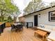 Outdoor back deck with a seating area, table and chairs, and rear door entrance at 2816 Eastport Rd, Charlotte, NC 28205