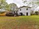 Exterior shot of the home's backyard with a deck, lawn and brick exterior at 2816 Eastport Rd, Charlotte, NC 28205