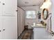 Bathroom with vanity, wood accents, a shower and vintage-style rug at 2816 Eastport Rd, Charlotte, NC 28205