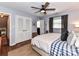 A primary bedroom featuring a ceiling fan, natural light, wood floors, and a walk-in closet at 2816 Eastport Rd, Charlotte, NC 28205