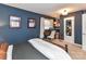 Stylish bedroom featuring a bed, a desk, and decorative wall hangings at 2816 Eastport Rd, Charlotte, NC 28205