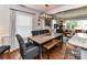 Dining area features wood floors, long table, upholstered chairs, bench and modern lighting at 2816 Eastport Rd, Charlotte, NC 28205