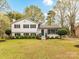 Charming two-story home featuring a freshly manicured lawn and beautiful landscaping at 2816 Eastport Rd, Charlotte, NC 28205
