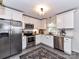 Bright kitchen features white cabinets, stainless steel appliances, granite countertops and an area rug at 2816 Eastport Rd, Charlotte, NC 28205