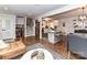 Spacious living area with hardwood floors, connecting to a modern kitchen and staircase at 2816 Eastport Rd, Charlotte, NC 28205