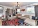 Bright living room features a large sectional sofa, area rug, and ample natural light at 2816 Eastport Rd, Charlotte, NC 28205