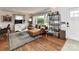 Cozy living room features hardwood floors, a comfortable leather sofa, and a stylish rug at 2816 Eastport Rd, Charlotte, NC 28205