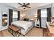 Relaxing main bedroom features a ceiling fan, neutral tones, and ample natural light at 2816 Eastport Rd, Charlotte, NC 28205