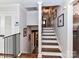 Traditional stairwell with a black railing and wooden steps, bright walls and flooring at 2816 Eastport Rd, Charlotte, NC 28205