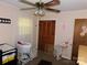 Bedroom with a crib and a bassinet, decorated with pink and white floral decals and a wooden closet at 2826 Drew Dr, Lancaster, SC 29720