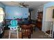 Inviting dining area featuring a wood table, ceiling fan, and blue accent wall at 2826 Drew Dr, Lancaster, SC 29720