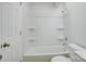 Bright bathroom features a shower and tub with a white surround and white fixtures at 2916 Iron Gate Ln, Charlotte, NC 28212