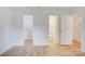 Bedroom with hardwood floors, two doors leading to closet and bathroom at 2916 Iron Gate Ln, Charlotte, NC 28212