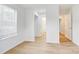 Bright bedroom with hardwood flooring, a window with blinds, and direct bathroom access at 2916 Iron Gate Ln, Charlotte, NC 28212