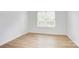 Bright room with hardwood flooring and a window with blinds at 2916 Iron Gate Ln, Charlotte, NC 28212
