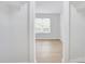 Bright closet leads to another bright room with hardwood flooring and a window with blinds at 2916 Iron Gate Ln, Charlotte, NC 28212