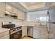 Modern kitchen featuring stainless steel appliances, white subway tile backsplash and white countertops at 2916 Iron Gate Ln, Charlotte, NC 28212