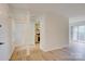 Open-concept living space with hardwood floors, leading to the kitchen, and a view of the outdoor patio at 2916 Iron Gate Ln, Charlotte, NC 28212