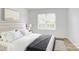 Sunlit primary bedroom featuring hardwood flooring, a comfortable queen-size bed, and large window at 2916 Iron Gate Ln, Charlotte, NC 28212