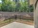 Concrete patio with a black metal fence, perfect for enjoying a private wooded backyard at 3002 Portico Pl, Tega Cay, SC 29708