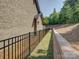 Backyard with an iron fence, retaining wall, and privacy landscaping at 3002 Portico Pl, Tega Cay, SC 29708