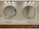 Bathroom featuring double vanity, undermount sinks, and round mirrors at 3002 Portico Pl, Tega Cay, SC 29708