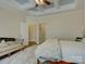 Bedroom featuring a tray ceiling, comfortable seating, and plenty of natural light from nearby windows at 3002 Portico Pl, Tega Cay, SC 29708